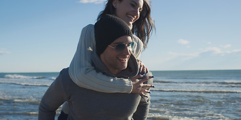 Image showing couple having fun at beach during autumn