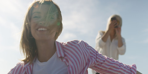 Image showing Two girl friends having fun photographing each other on vecation