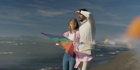 Image showing Happy couple having fun with kite on beach