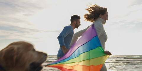 Image showing Happy couple having fun with kite on beach