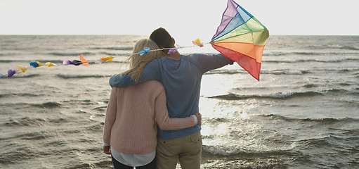 Image showing Happy couple having fun with kite on beach