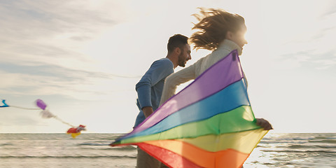 Image showing Happy couple having fun with kite on beach