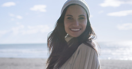 Image showing Girl In Autumn Clothes Smiling on beach