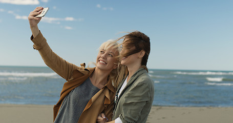 Image showing Girls having time and taking selfie on a beach