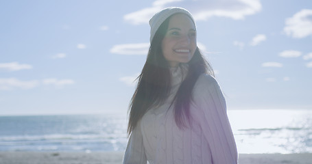 Image showing Girl In Autumn Clothes Smiling on beach