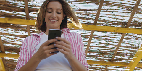 Image showing Smartphone Woman Texting On Cell Phone At Beach