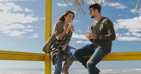 Image showing Group of friends having fun on autumn day at beach