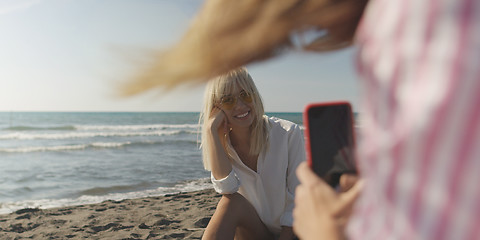 Image showing Two girl friends having fun photographing each other on vecation