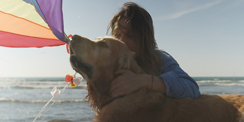 Image showing Woman holding kite at beach on autumn day