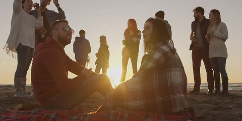 Image showing Friends having fun at beach on autumn day