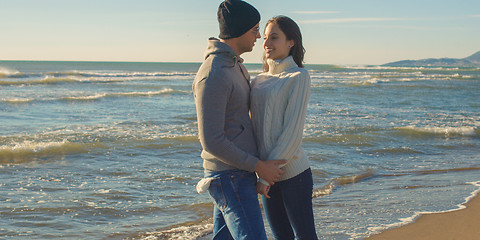 Image showing Couple having fun on beautiful autumn day at beach