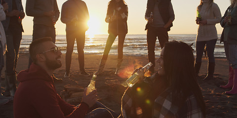 Image showing Friends having fun at beach on autumn day