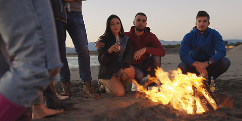 Image showing Friends having fun at beach on autumn day