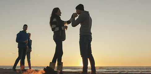 Image showing Friends having fun at beach on autumn day