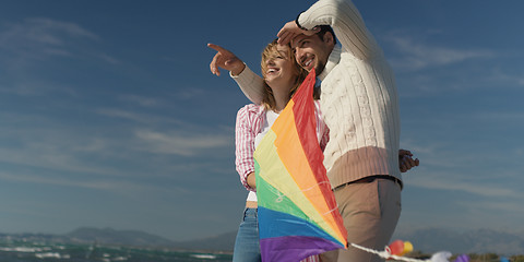 Image showing Happy couple having fun with kite on beach