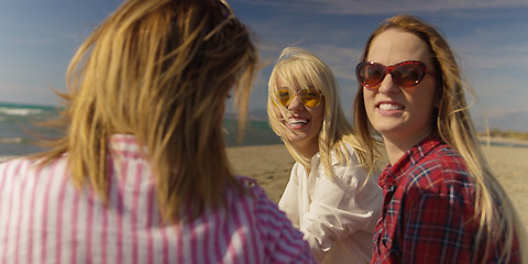 Image showing Group of girlfriends having fun on beach during autumn day