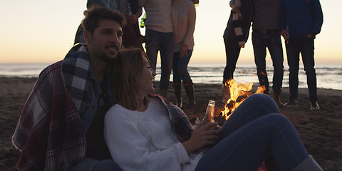 Image showing Friends having fun at beach on autumn day