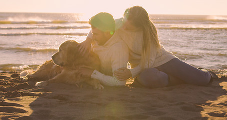 Image showing Couple with dog enjoying time on beach