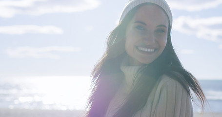 Image showing Girl In Autumn Clothes Smiling on beach