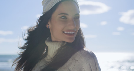 Image showing Girl In Autumn Clothes Smiling on beach