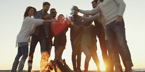 Image showing Friends on beach party drinking beer and having fun