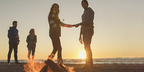 Image showing Friends having fun at beach on autumn day