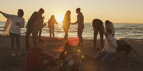 Image showing Friends having fun at beach on autumn day