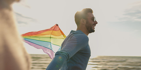 Image showing Happy couple having fun with kite on beach