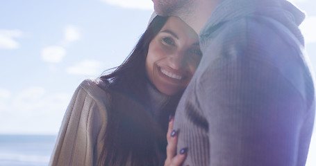 Image showing Couple having fun on beautiful autumn day at beach