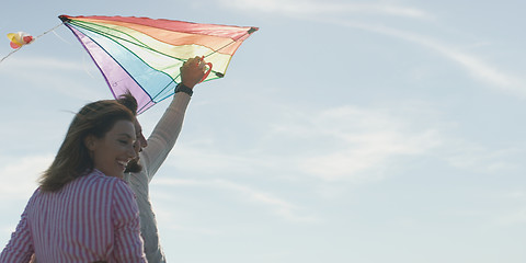 Image showing Happy couple having fun with kite on beach