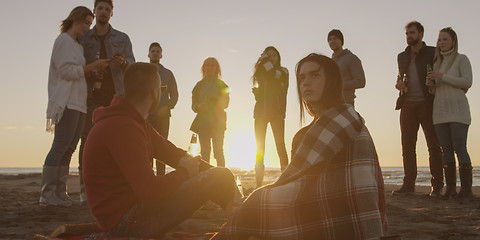 Image showing Friends having fun at beach on autumn day