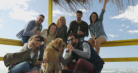 Image showing Group of friends having fun on autumn day at beach