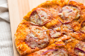 Image showing close up of homemade pizza on wooden table