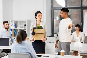 Image showing fired sad female office worker leaving