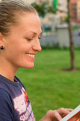 Image showing attractive woman reading in the park