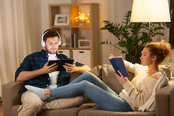 Image showing couple with tablet computer and book at home