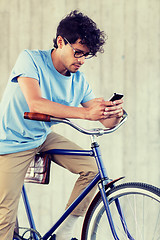 Image showing man with smartphone and fixed gear bike on street