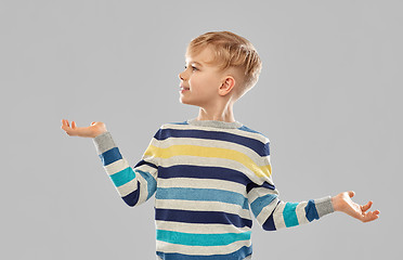 Image showing smiling boy holding something on empty hands