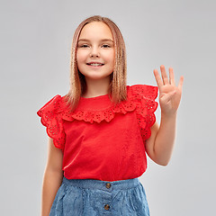 Image showing smiling girl in red shirt showing four fingers