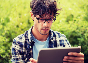 Image showing man in glasses with tablet pc computer outdoors