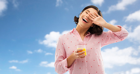 Image showing happy yawning young woman in pajama with juice