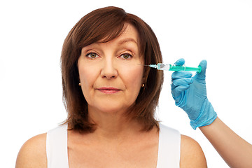 Image showing senior woman and surgeon hand with syringe