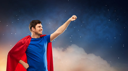 Image showing man in red superhero cape over night sky