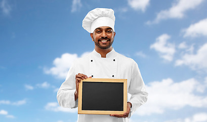 Image showing happy male indian chef in toque with chalkboard