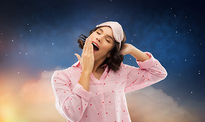 Image showing happy young woman in pajama and eye sleeping mask