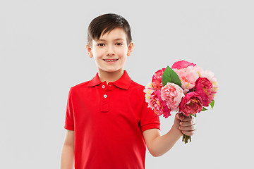 Image showing smiling boy with bunch of peony flowers