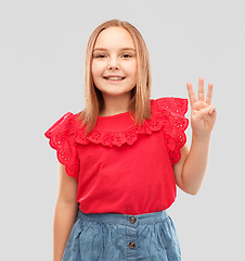 Image showing smiling girl in red shirt showing three fingers