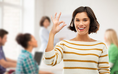 Image showing happy smiling student girl showing ok at school