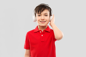 Image showing smiling boy in headphones listening to music