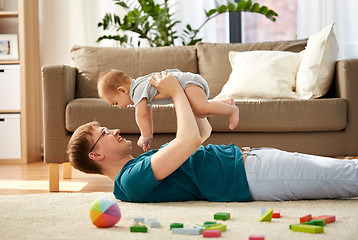 Image showing happy father with little baby son playing at home